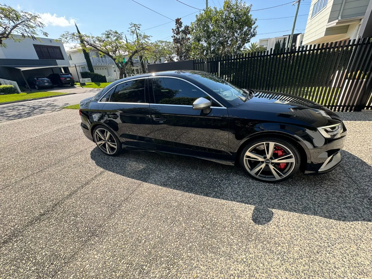 Side profile of the black Audi RS3, with silver wheels and red brake calipers